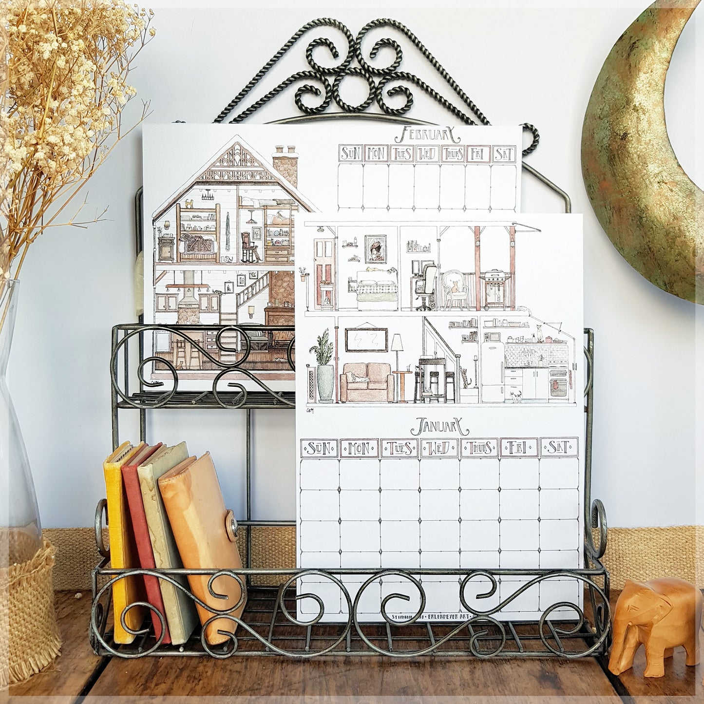 Erlenmeyer cat calendar showing the months of February and January displayed on a wire frame display rack.