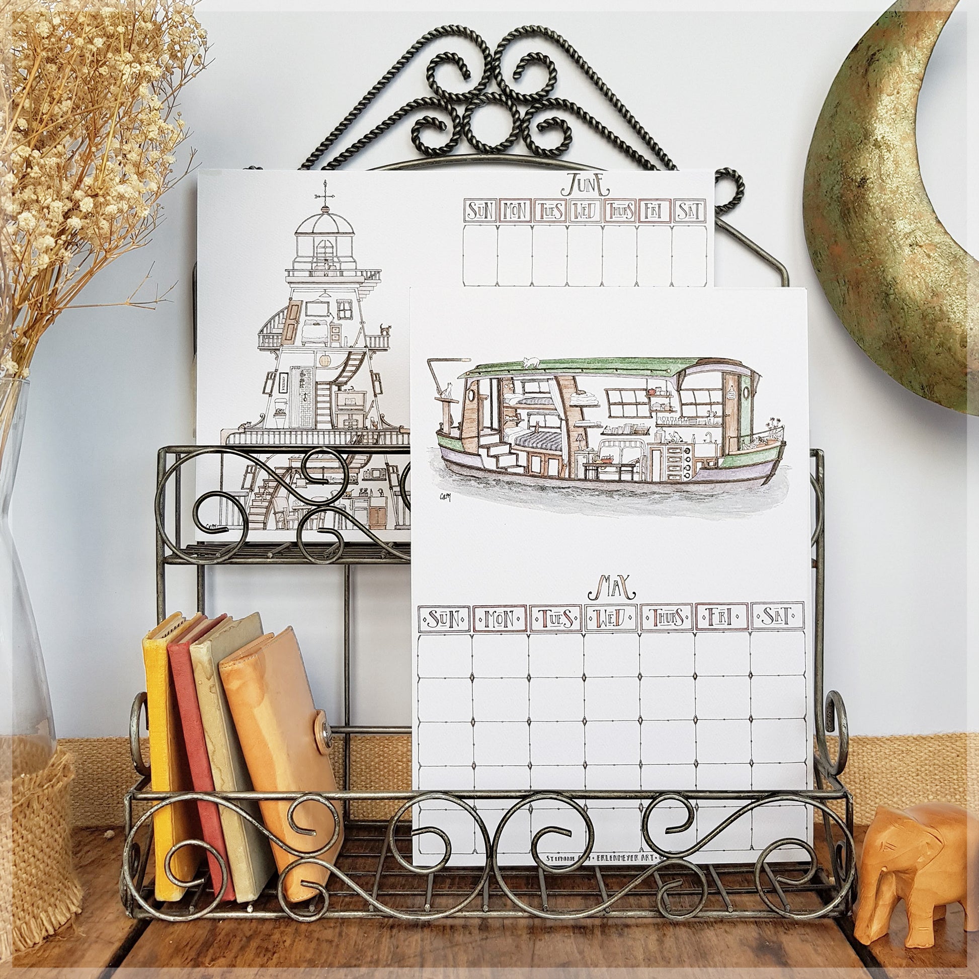 Erlenmeyer cat calendar showing the months of June and May , displayed on a wire frame display rack.