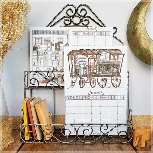 Erlenmeyer cat calendar showing the months of October and September mounted on a wire frame display rack.