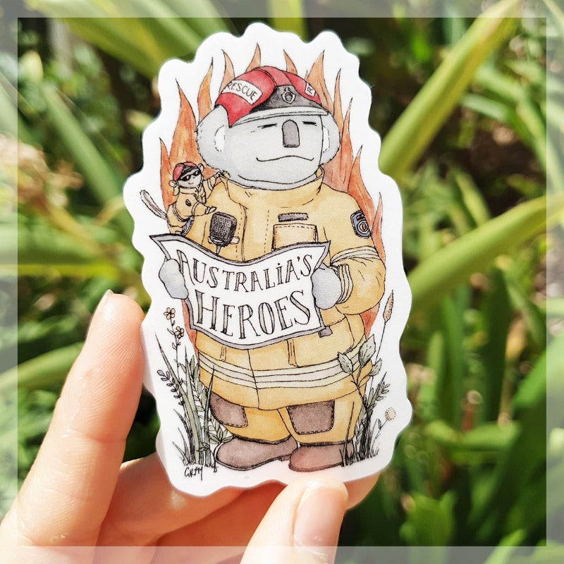 A Koala firefighter with his sugar glider assistant sitting on his shoulder. This is a sticker we sell to raise money and awareness for Australia fire relief.