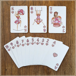 Hand Illustrated Circus playing cards showing the suit of hearts. This suit shows off the circus acrobats and fortune teller