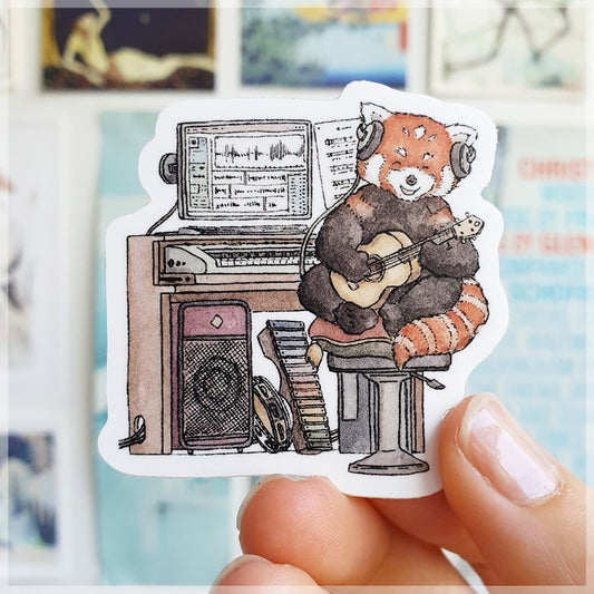 The little red panda strumming away on his ukulele .